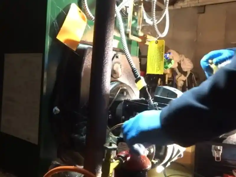 Technician inspecting a commercial boiler system in a Bonita Springs facility