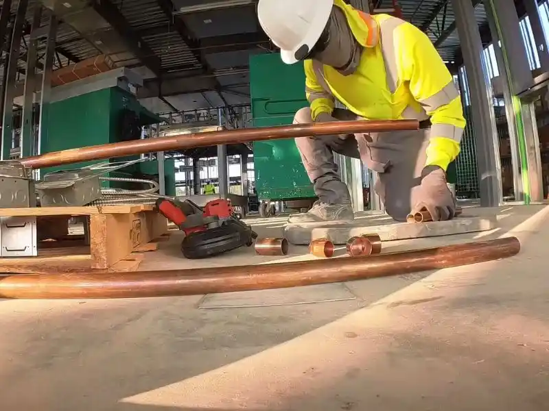 Plumber servicing commercial plumbing fixtures in a Bonita Springs office building