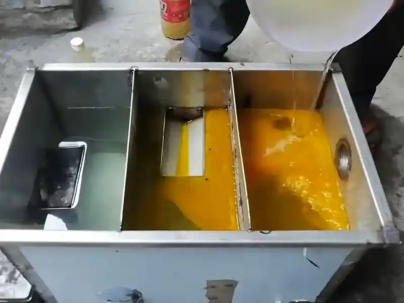 Technician servicing a commercial grease trap at a Bonita Springs restaurant