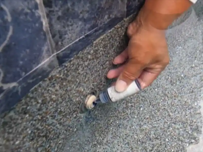Technician performing pool leak detection at the equipment pad in Bonita Springs
