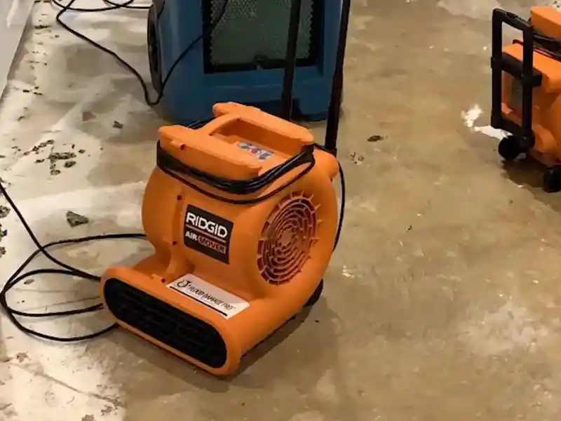 Industrial dehumidifiers and fans running during water mitigation in a Bonita Springs home